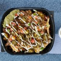 Large Birria Loaded Nachos · Fresh tortilla chips with birria topped with pico de gallo, sour cream guac, and cheese melt...