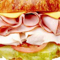 Ham, Turkey & Cheese Croissant Sandwich · Includes cheese (your choice), lettuce, tomato, and mayonnaise. Dill pickle spear, pepperonc...