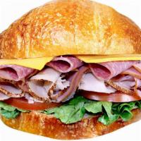 Ham, Turkey, Salami & Cheese Croissant Sandwich · Includes cheese (your choice), lettuce, tomato, and mayonnaise. Dill pickle spear, pepperonc...