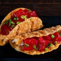 Spicy Tuna Taco · Tuna, Ponzu Mayo, Sushi Rice and Green Onions in a Gyoza Shell. Order comes with two tacos.