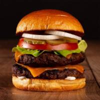 The Double Cheeseburger · Two beef patties, lettuce, tomato, onion, pickles, mayo, and melted cheddar cheese on a brio...