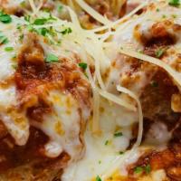 Meatballs Al Forno · Three housemade meatballs bolognese with melted mozzarella, fresh parmigiano