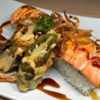 Volcano · Very spicy. In: imitation crabmeat, jalapeno, avocado. Out: baked spicy salmon, fried onion.