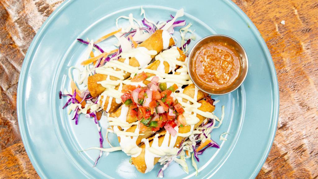 Red Chile Chicken Flautas · Pulled Free Range Red Chile Chicken rolled in Corn Tortillas and fried crisp with Crema, Cotija Cheese, Pico de Gallo, and Avocado Crema