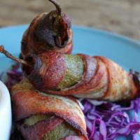 Spicy Bacon Wrapped Jalapeños · Three spicy jalapeños stuffed with Laura Chenel goat cheese and wrapped in applewood smoked ...