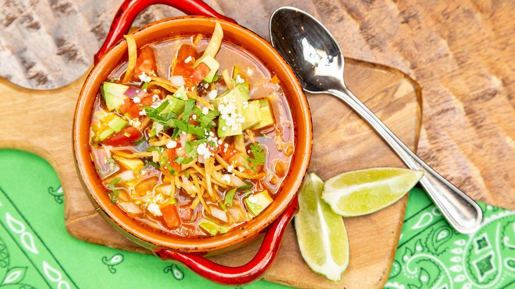 Tortilla Soup · Poached Rocky's Free Range Chicken in a spicy roasted Chicken Broth with Crispy Corn Tortilla Strips, Avocado, Chopped Tomatoes and Cilantro