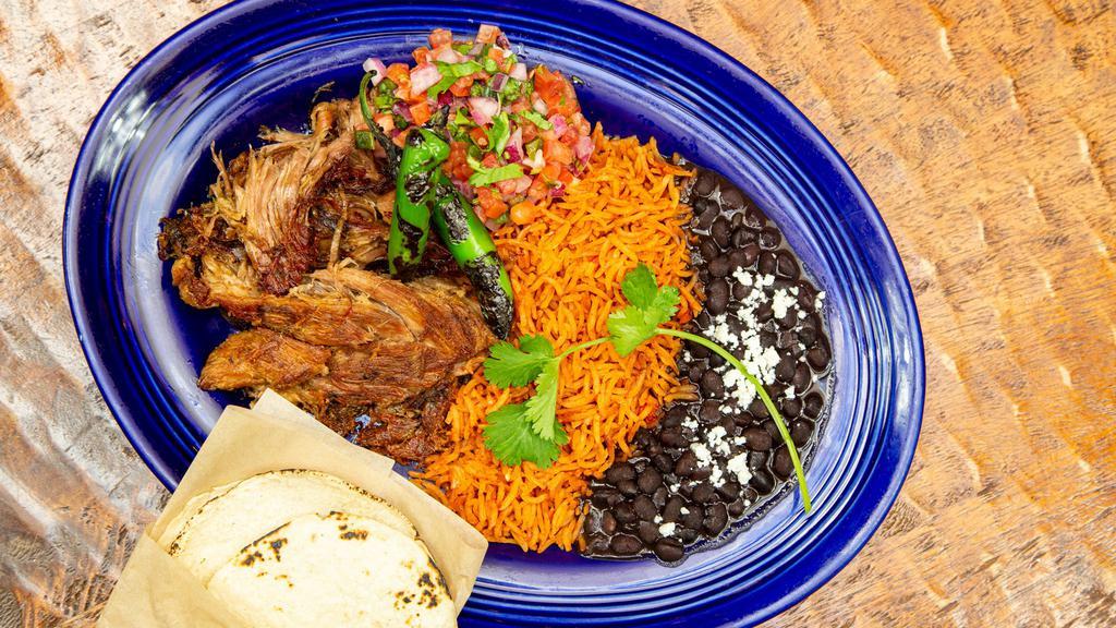 Apple - Jalapeño Carnitas · Crispy and Tender Pork Carnitas glazed with Brown Sugar, Apples & Pickled Jalapenos,  served with Red Chile Rice, Refried Beans and your choice of tortillas.