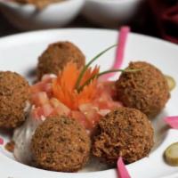 Falafel · Fava and garbanzo bean croquette, served with lettuce, tomatoes, and tahini sauce.