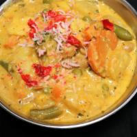 Korma · Sauteed mixed vegetables cooked in creamy sauce, topped with nuts, raisins.