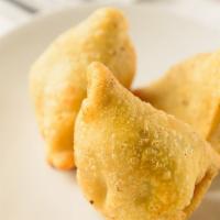 Vegetable Samosa · Crisp pastry filled with potatoes and peas.
