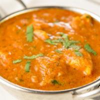Chicken Curry · Boneless chicken cooked with onions, tomatoes, fresh ginger, garlic, and spices.