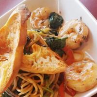 Jungle Crevette (Shrimp Scampi) · Sautéed shrimp with caramelized onions and
bell peppers finished with spinach over pasta
wit...