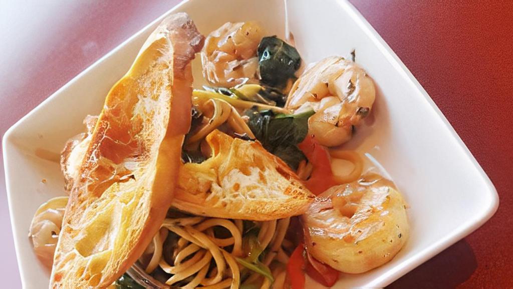 Jungle Crevette (Shrimp Scampi) · Sautéed shrimp with caramelized onions and
bell peppers finished with spinach over pasta
with a side of baguette.
