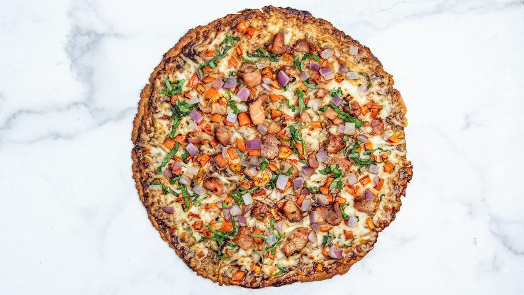 Bbq Chicken Pizza · Reduced fat mozzarella cheese, housemade BBQ sauce, marinated chicken, diced tomatoes, red onions, and fresh basil served on our signature cauliflower crust.