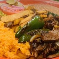 Carne Asada Plato · Served with pieces of steak, rice, beans, French fries, salad, and guacamole. Cooked with on...