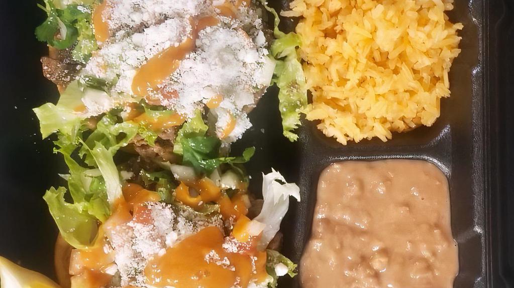 2 Sopes (Hand Made) With Rice And Beans · Includes beans, lettuce, pico de gallo, sour cream, cheese, and salsa