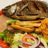 Mojarra Frita · Served with rice, beans, salad, guacamole, lemon, and French fries