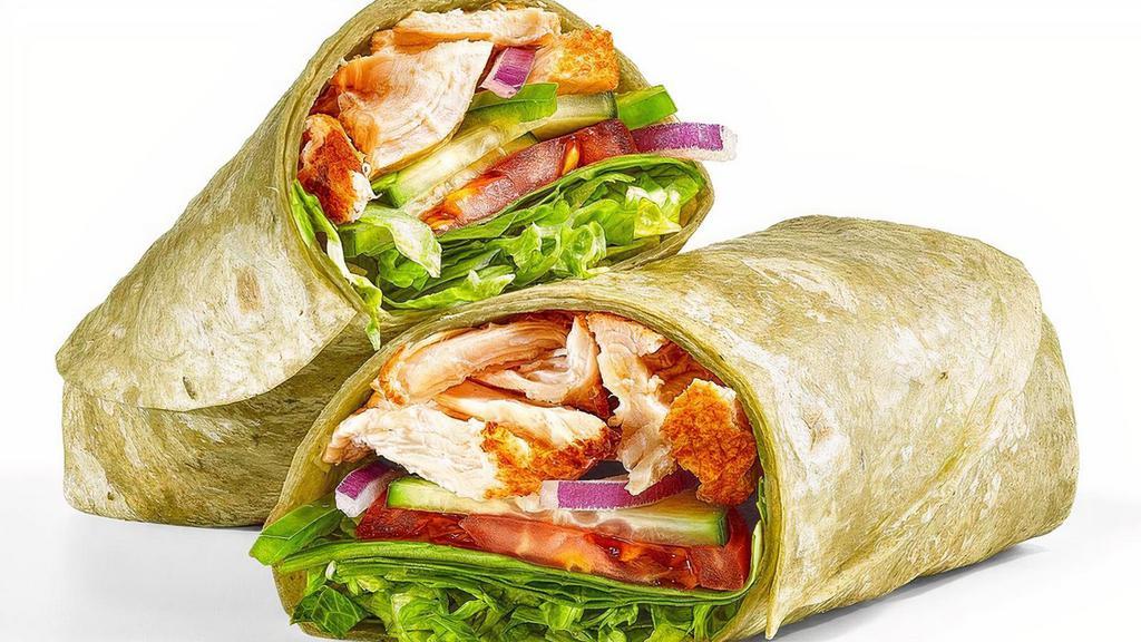 Rotisserie-Style Chicken · A generous portion of juicy rotisserie-style chicken with fresh lettuce, baby spinach, tomatoes, cucumbers, green peppers and red onions. Served in a spinach wrap.
