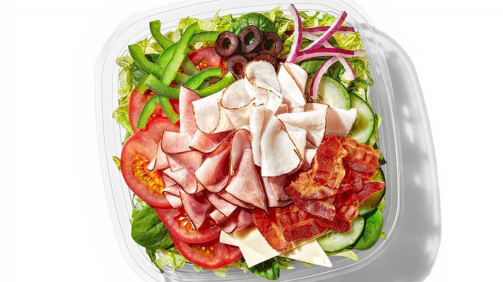 All-American Club® · Our classic All-American Club® is now a classic salad, too. Oven roasted turkey, Black Forest ham, hickory smoked bacon are the leaders of this club. Then we add American cheese and crisp lettuce, baby spinach, tomatoes, cucumbers, green peppers, red onions and black olives.