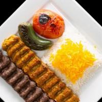 Beef & Chicken Luleh · Two skewers of ground beef and a skewer of ground up chicken thigh seasoned with parsley, on...