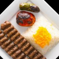 Beef Luleh Kebab · Two skewers of ground beef served with rice, grilled tomato and jalapeño.