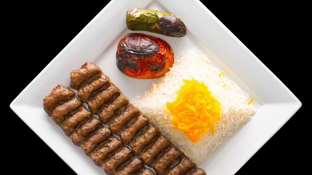 Beef Luleh Kebab · Two skewers of ground beef served with rice, grilled tomato and jalapeño.