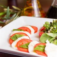 Caprese Salad · Fresh mozzarella, mixed greens, tomatoes, avocado and basil.