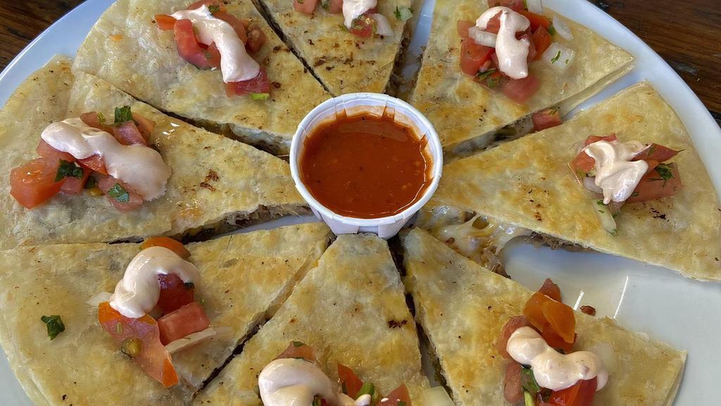 Quesadilla · Chicken or carnitas, cheddar and jack cheese, roasted poblano chile, chipotle sour cream and pico de gallo (substitute carne asada for an extra charge)