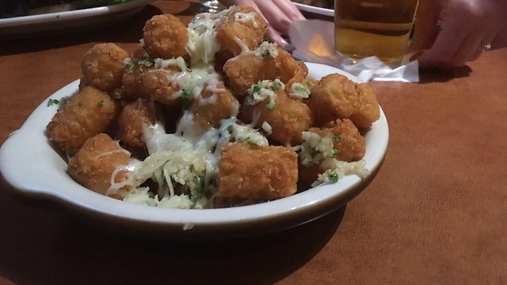 Garlic Tots · Tater tots tossed with garlic, parsley, salt and pepper topped with parmesan cheese
