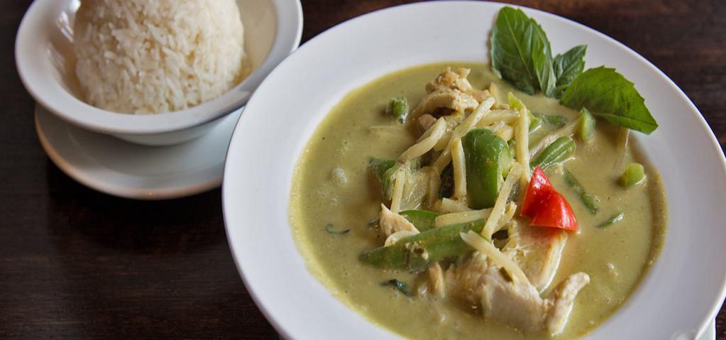 Green Curry · Simmered green curry in coconut milk with eggplant, bamboo shoots, bell peppers, and Thai basil.