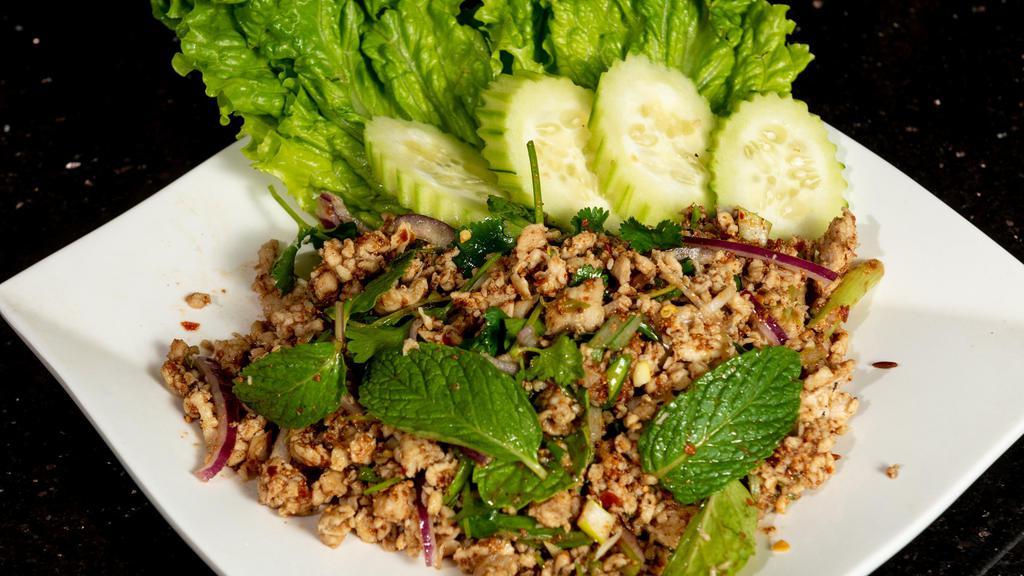 Larb · Choice of ground chicken, ground pork or ground beef tossed in red onions, mint leaves, cilantro, limes, and rice powder. Served over a bed of mixed salad and fresh cucumber.
