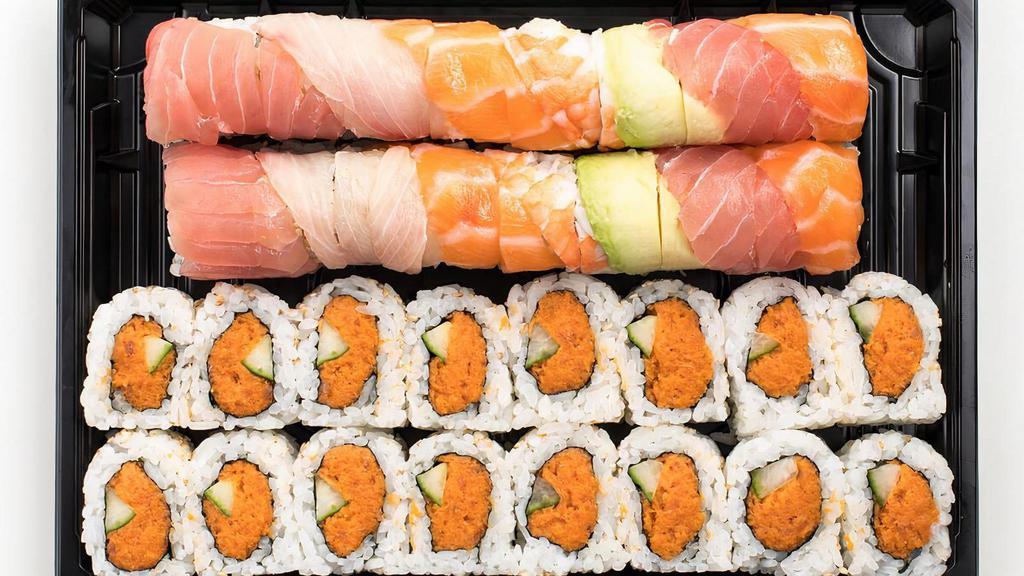 Rainbow† & Spicy Tuna Roll · Rainbow Roll: The classic California Roll† topped with tuna, yellowtail, shrimp, salmon and avocado to look like a rainbow and Spicy Tuna Roll: Fresh tuna mixed with spicy mayo sauce, combined with cucumber and rolled in seaweed and rice