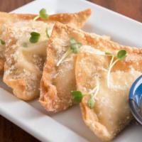 Pineapple Cheese Wontons · Crispy wontons filled with pineapple, cream cheese and green onions; served with pineapple d...