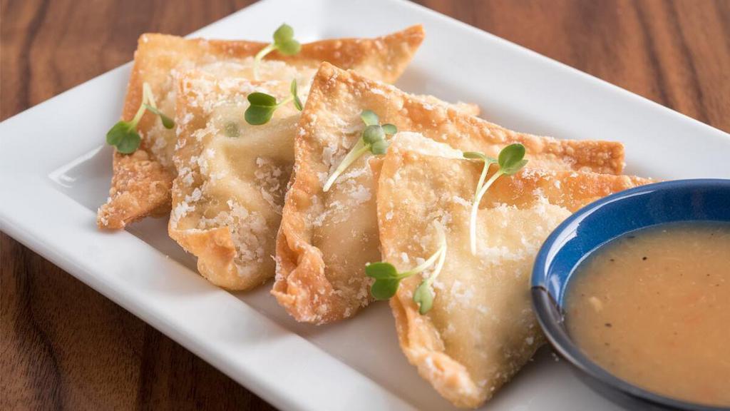 Pineapple Cheese Wontons · Crispy wontons filled with pineapple, cream cheese and green onions; served with pineapple dipping sauce.