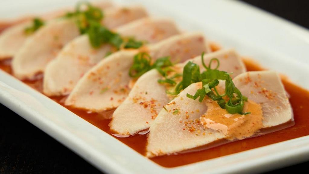 Chili Garlic Albacore Tuna* · Thinly sliced albacore with chili ponzu sauce; topped with chili mayo, green onions and garlic chips.