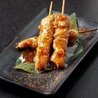 Chicken Skewers · Three skewers of chicken cooked in sake teriyaki sauce; topped with sesame seeds and togaras...
