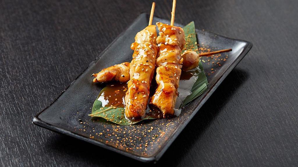 Chicken Skewers · Three skewers of chicken cooked in sake teriyaki sauce; topped with sesame seeds and togarashi.