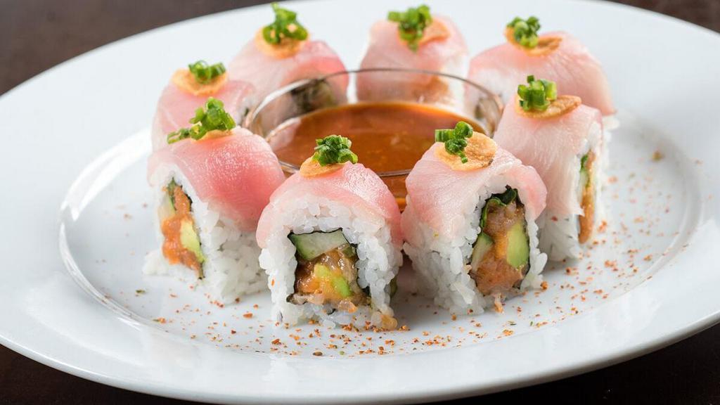 Chili Ponzu Yellowtail Roll* · Spicy yellowtail mix rolled with cucumber, avocado, jalapeño and cilantro; topped with green onion, crispy garlic, togarashi and served with chili ponzu sauce
