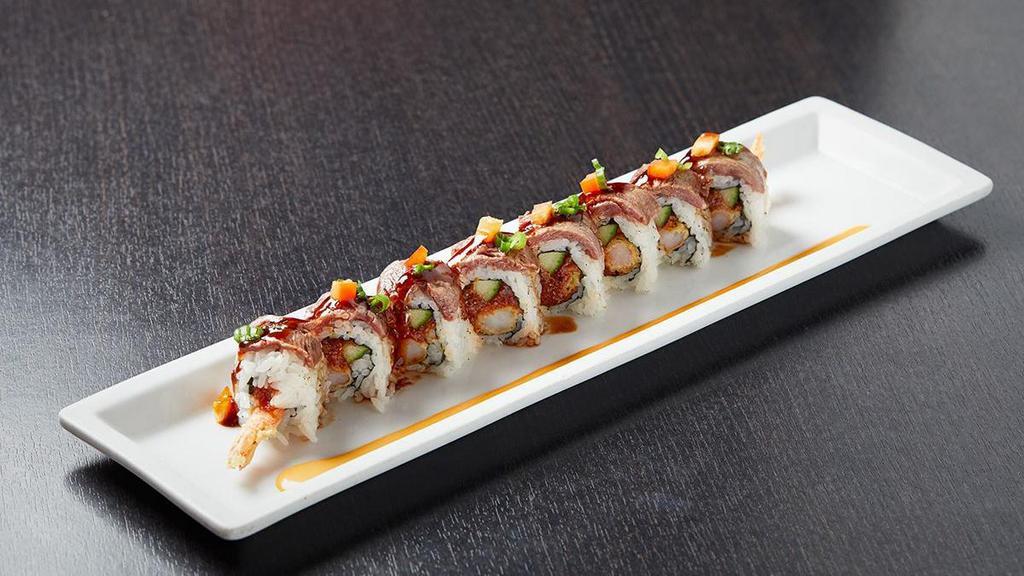 Surf & Turf Roll · Shrimp and asparagus tempura rolled and topped with seared filet mignon; finished with green onions, red bell peppers, fried onions and garlic chips; served with creamy wasabi sauce.