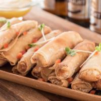Lobster Spring Rolls · Lobster mixed with mango, cream cheese and mild peppers, wrapped in wonton paper and lightly...