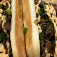 Beef Tapa Sandwich · Filipino-style marinated beef with house-made tapa sauce, caramelized onions, lettuce, green...