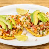 Ceviche Tostada · Fish or Shrimp cooked in lime juice with tomatoes - onions - carrots - cilantro - topped wit...