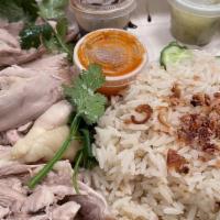 Hainan Chicken (Dark Meat Only) · Hainan chicken (thigh meat) served with garlic rice, fried shallots, pickled cucumbers, ging...