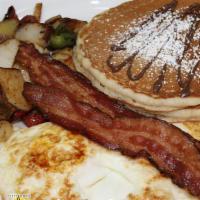 American Breakfast · 2 buttermilk pancakes, 2 eggs, your choice of 2 breakfast meats and side of house potatoes.
