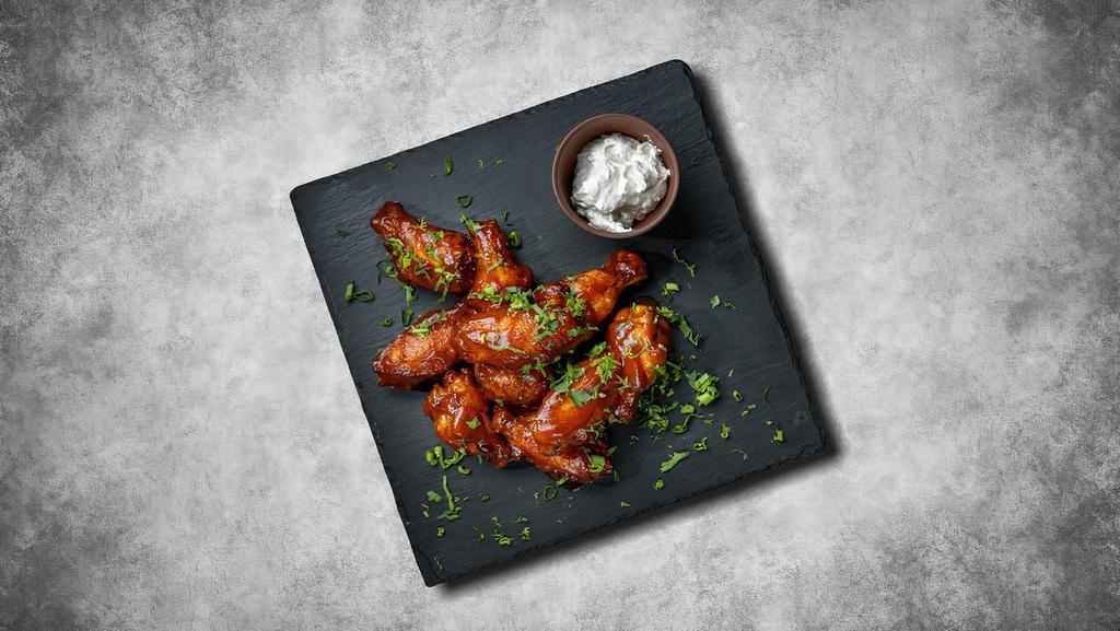 Classic Chicken Wings · Deep-fried and then coated with your choice of wing sauce.