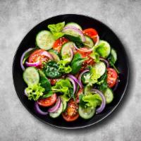 Wedge House Salad · Our house salad topped with green leaf lettuce, diced tomatoes, cucumbers, and onions served...