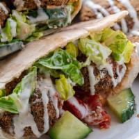 Falafel Sandwich (No Spicy) · Sesame bread, hummus, falafel, pickles, pickled turnip, cucumber and tomato salad and tahini...