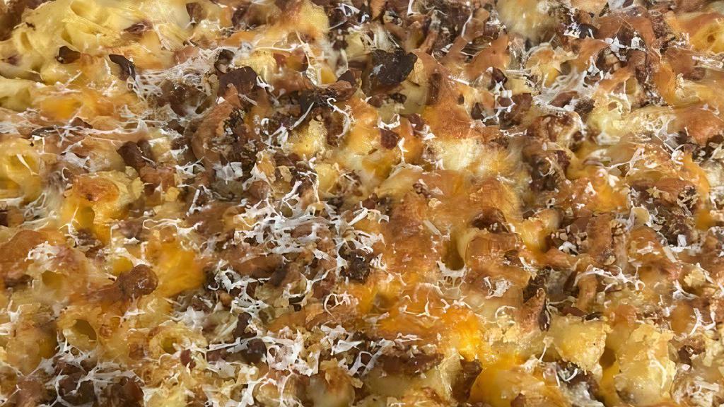 Mac Attack · Not your mom's Kraft Macaroni. This is an adult's version of MAC and Cheese with Garlic, jack, cheddar and parmesan over macaroni topped with bacon and panko bread crumbs.