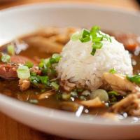 Famous Gumbo Bowl · Chicken thigh meat, smoked pork sausages, okra, shrimp served on jasmine rice.