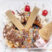 Banana Split · Banana split, strawberry and vanilla ice-cream topped with banana whipped cream, chocolate s...